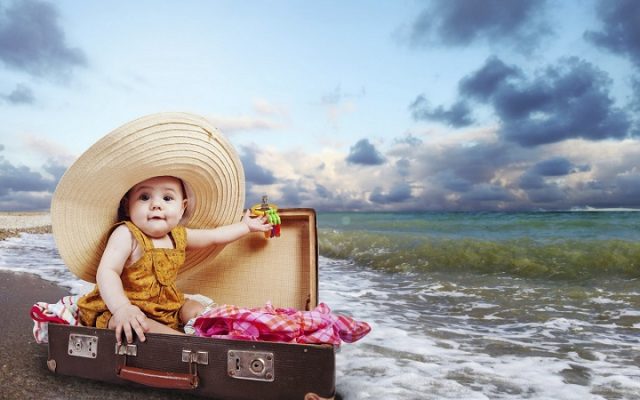 Little traveler in suitcase
